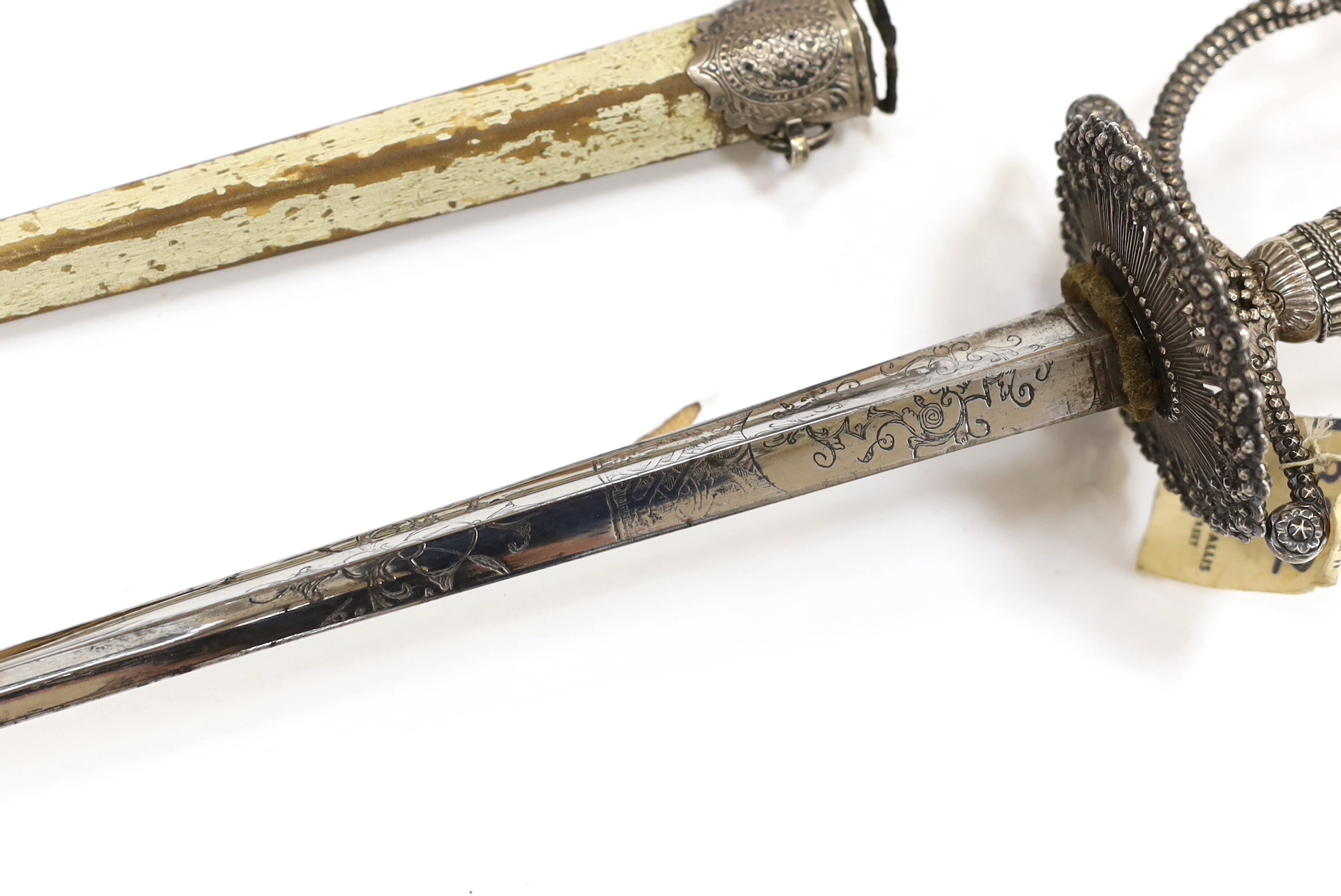 An English small sword, c.1775, pierced with facetted stud work, silver tape and wire bound grip, triangular section etched blade, in its original vellum scabbard and silver mounts, top mount engraved Dieltry Royal Excha